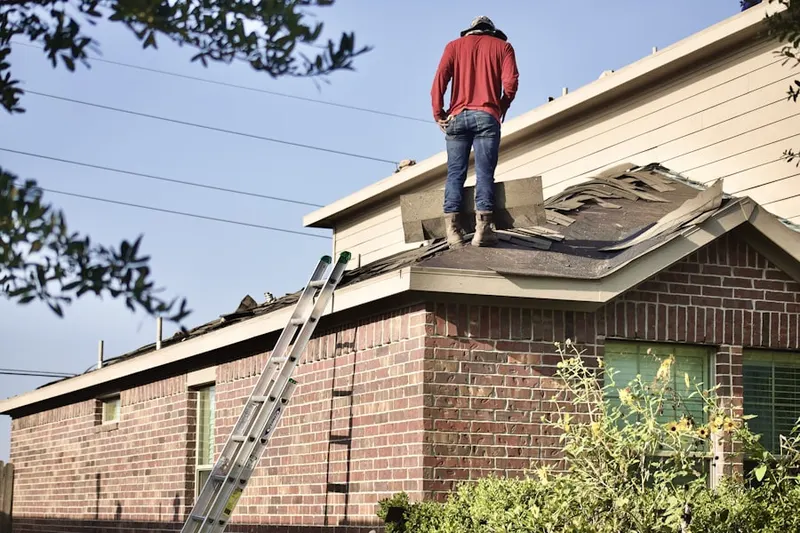 Professional roofer working on a residential roof in Allaire